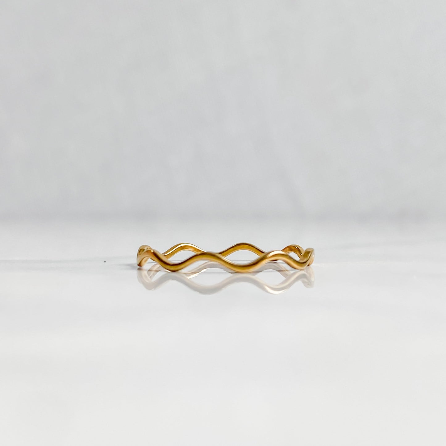 Packshot de la bague ondulée dorée Naïa en acier inoxydable 18K