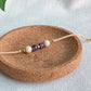 Bracelet cordon ajustable Zéphyr en améthyste et pierre de rivière, bijou artisanal fait main à Montréal