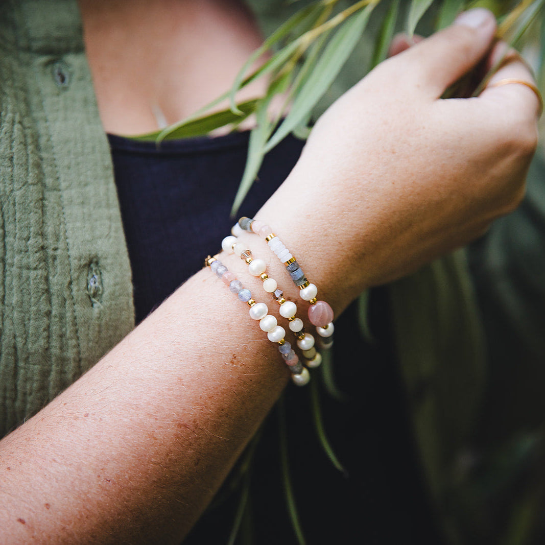 Bracelet Nérida en perles d’eau douce porté en stacking avec d’autres bijoux.