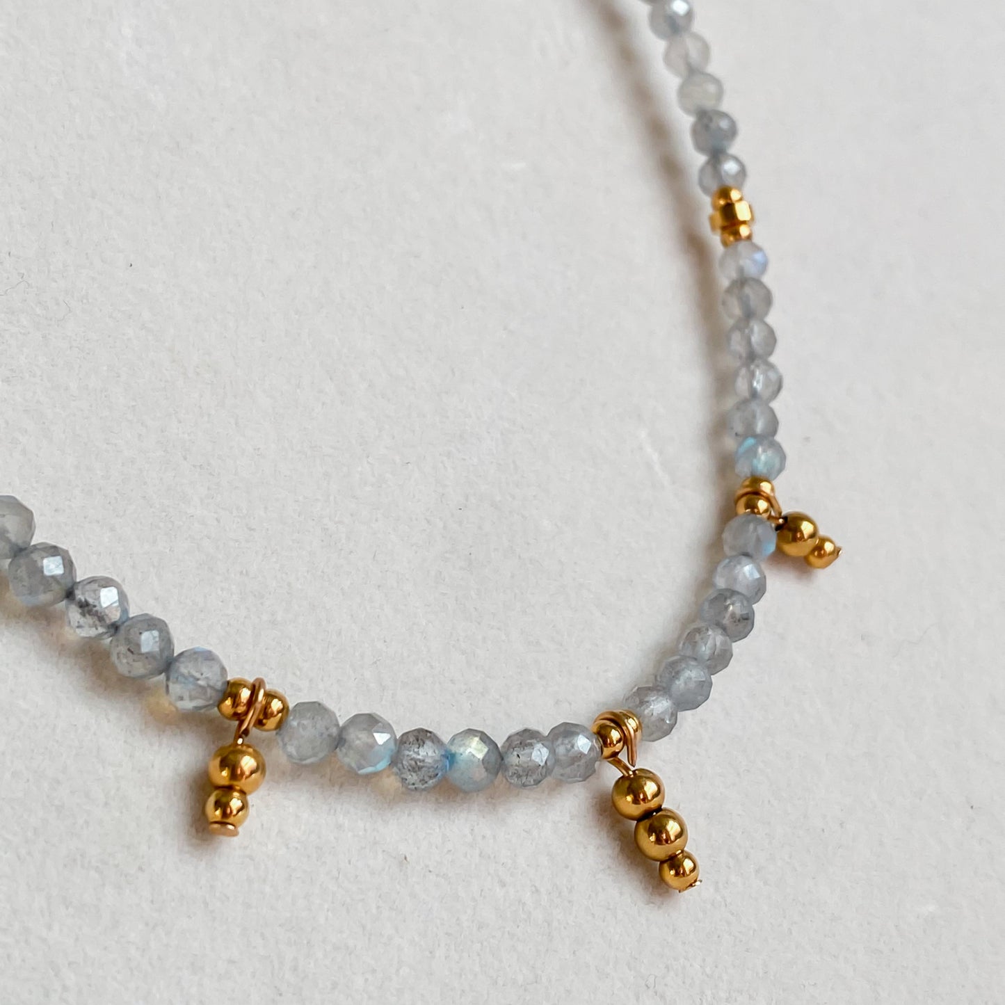 Détail du collier en pierres de labradorite avec billes dorées plaqué or 18K