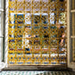 Grille dorée aux motifs ajourés ayant inspiré le collier Rosace