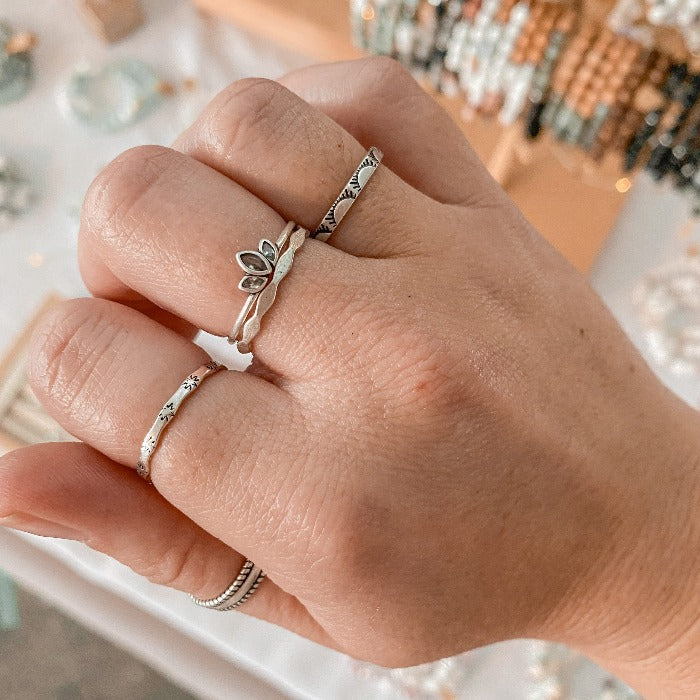 Bague Aube en argent sterling 925 portée en combinaison avec les bagues Sunny, Onde, Lotus et Jon, créant un look rayonnant et élégant, parfait pour ajouter une touche de lumière et de chaleur à ton ensemble.